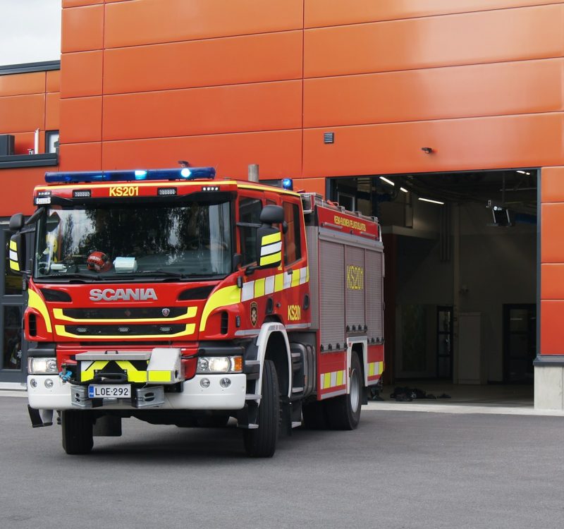 a fire truck parked in front of an orange building